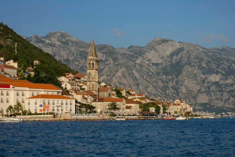 a small fishing village along the waterfront next to a cliff