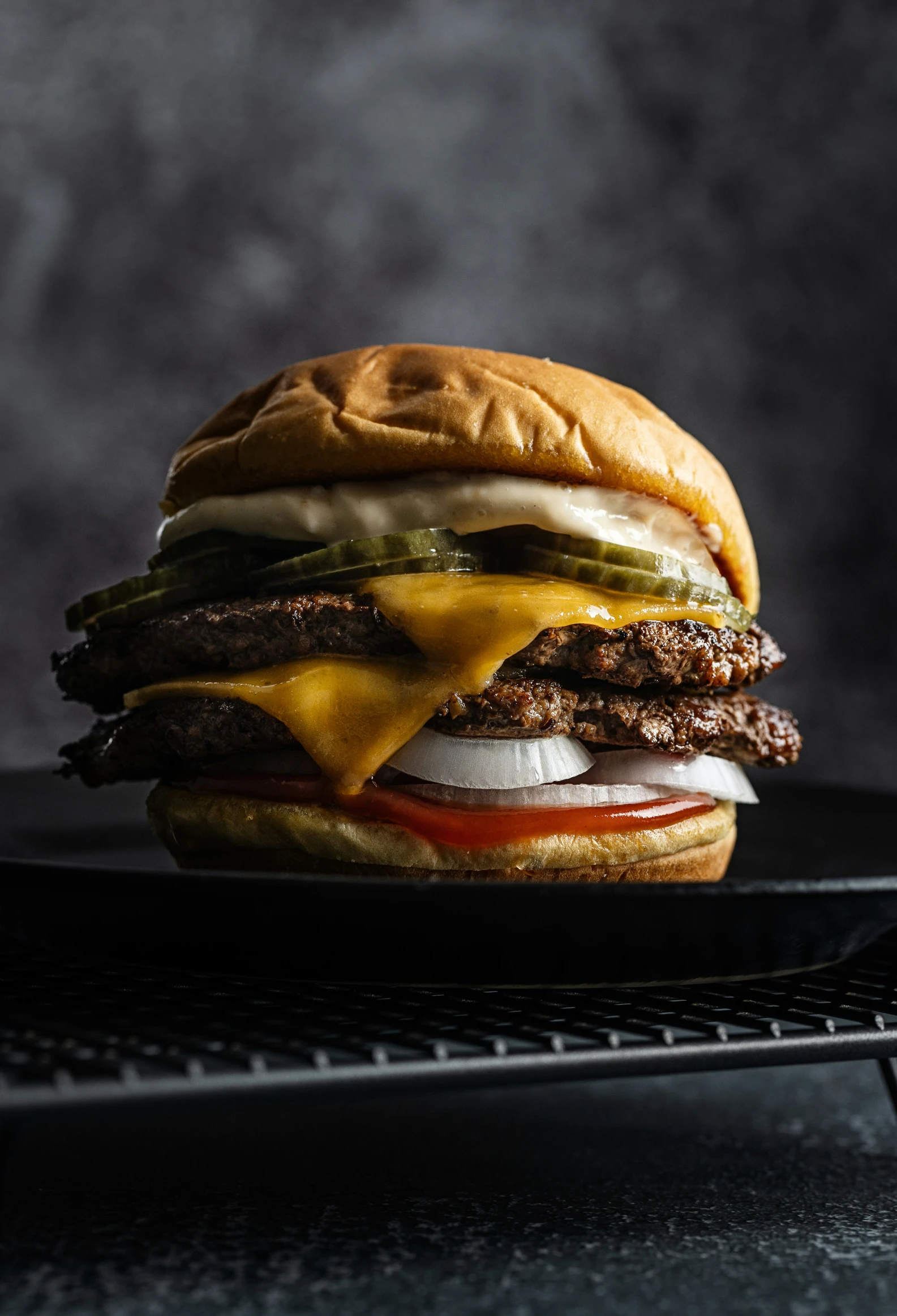 hamburger with cheese, pickles and pickle on plate