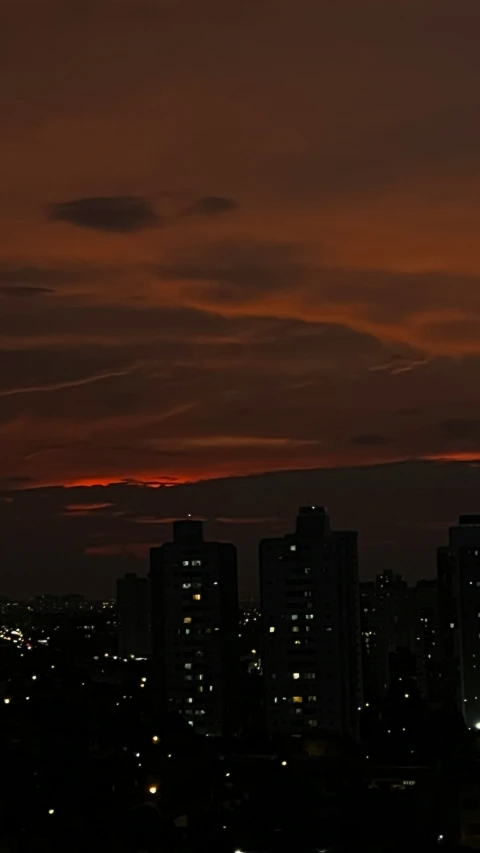 an airplane flies over the city of a big city at night