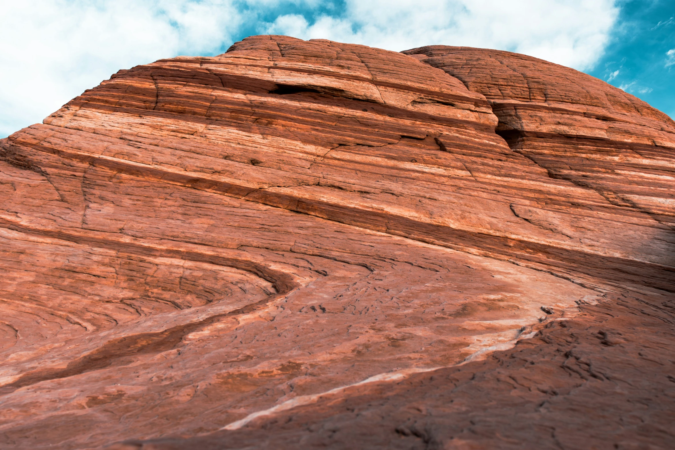 large red rock with a mountain peak next to it