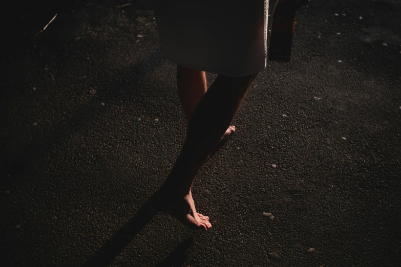 the bare legs of a woman with short nail polish