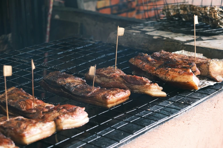 a bunch of food is cooking on a grill