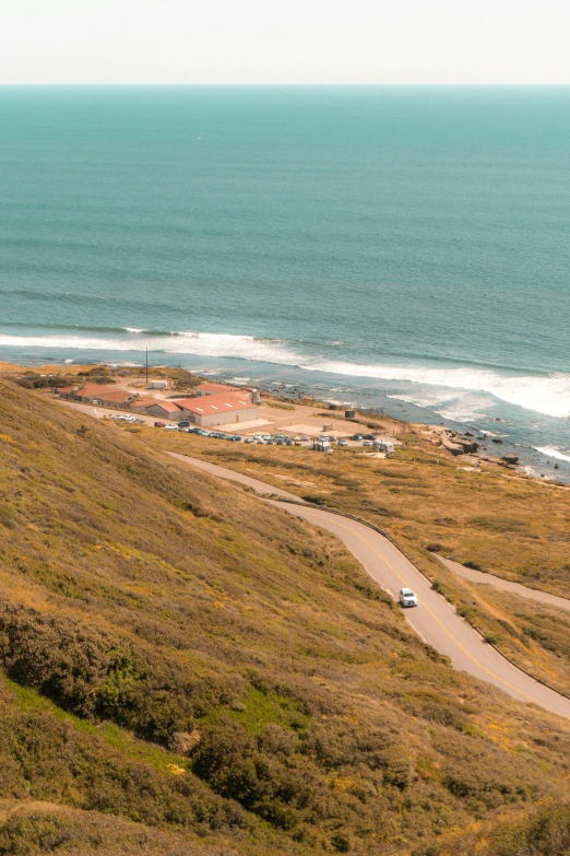 an ocean view of a truck driving on the beach