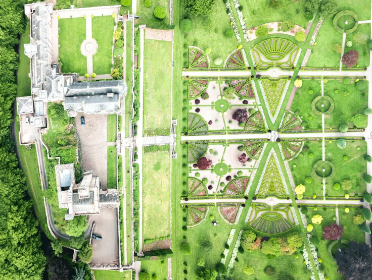 an aerial view of a large garden with many green trees