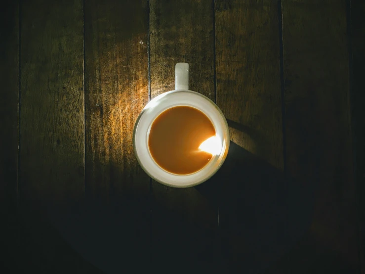 an aerial s of a light that is on a wood surface