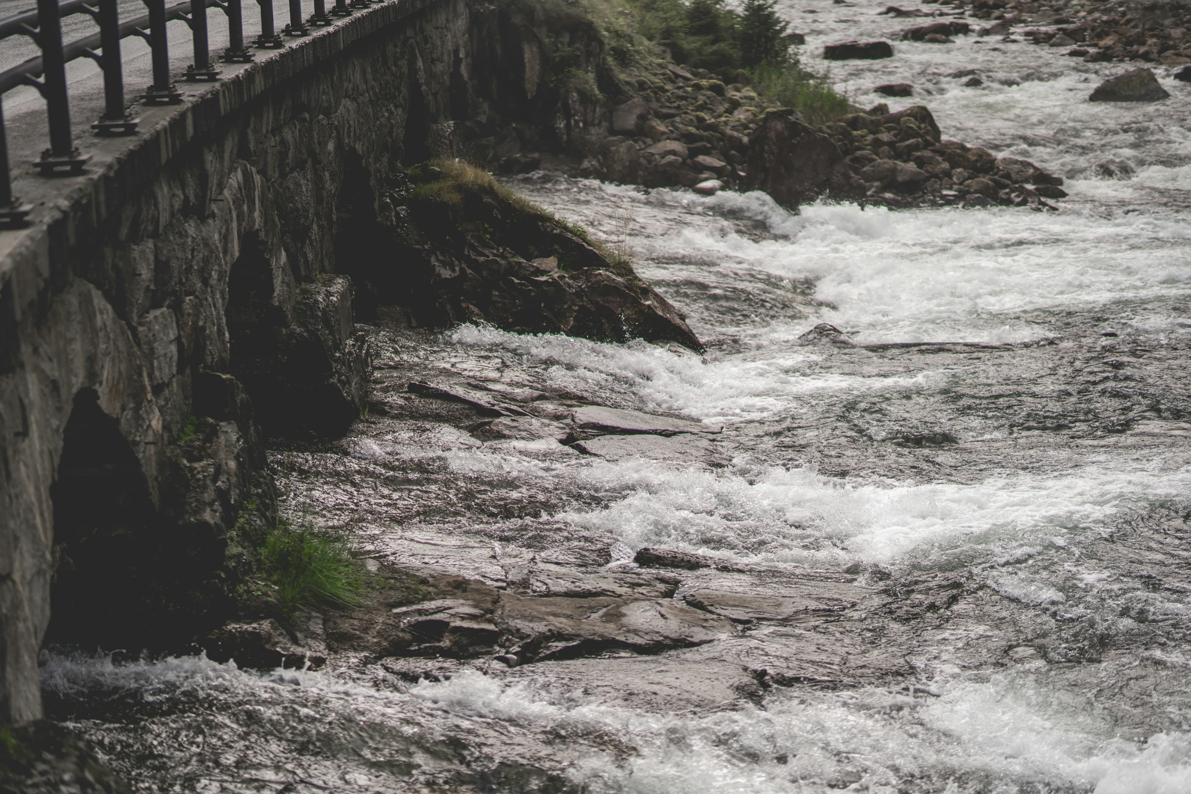 the bridge is built on the side of a stream