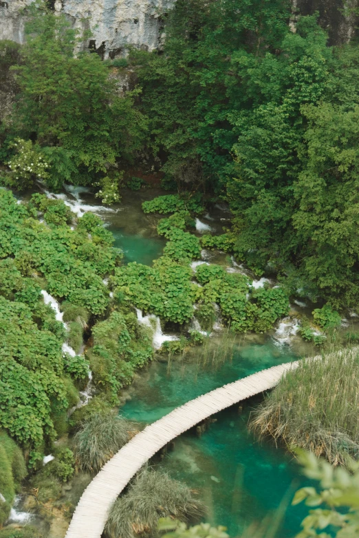 this is an image of a road leading to a waterfall