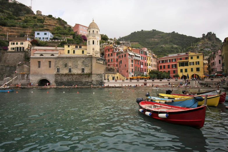 several boats are moored on the dock near colorful houses