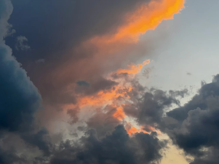 a airplane flying up in the air on a cloudy day