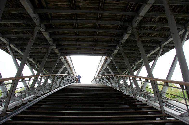 a man standing in the top of some metal stairs