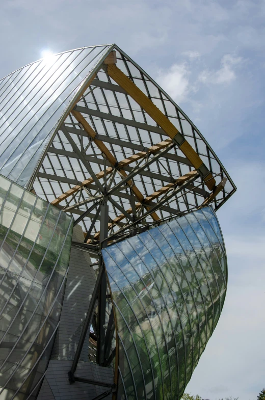 a large metal structure with lots of windows under a blue sky