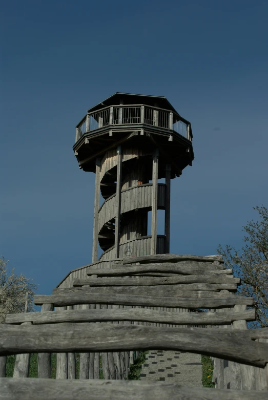 an old wooden structure with stairs and a balcony