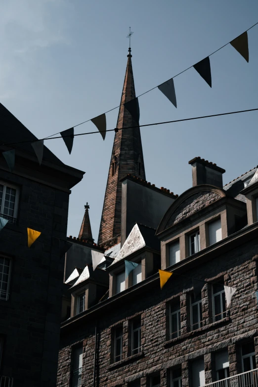 a building with a steeple and black tile