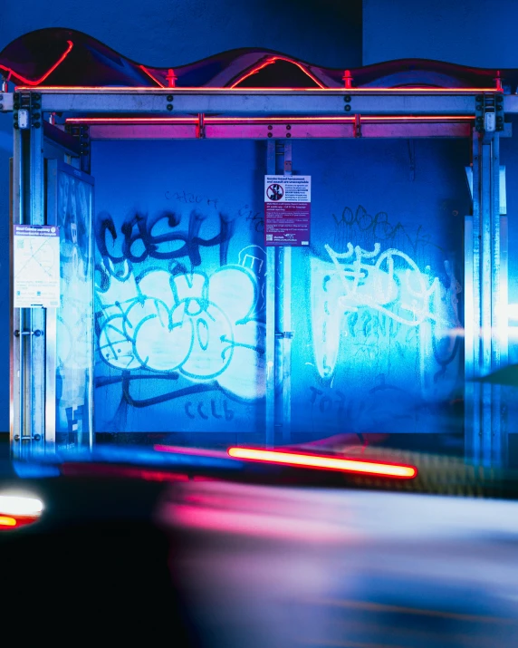 a blue wall with red lights over it at night