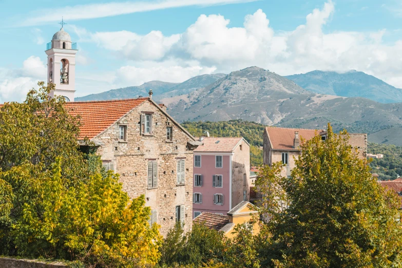 an image of mountains and a town with towers