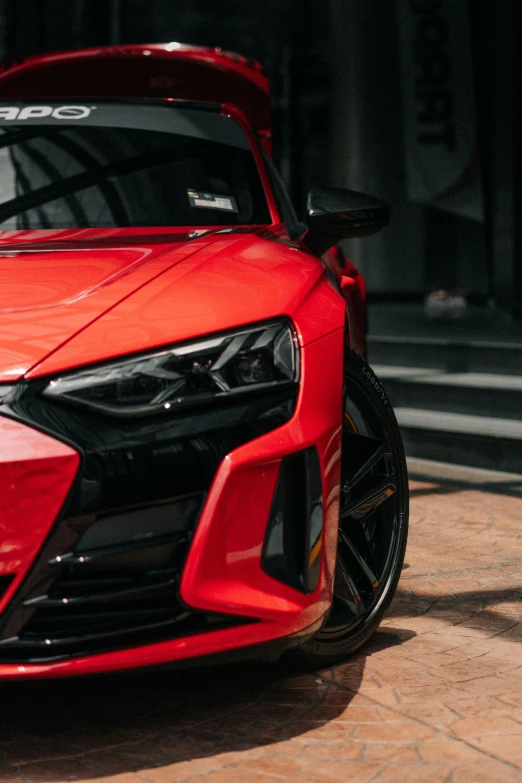 a red sports car is parked on a driveway