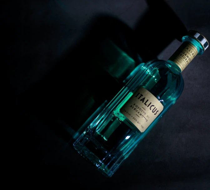 bottle of aqua wine sitting on black surface