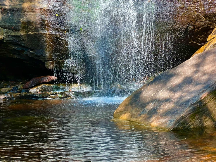 a waterfall with falling water coming from the top