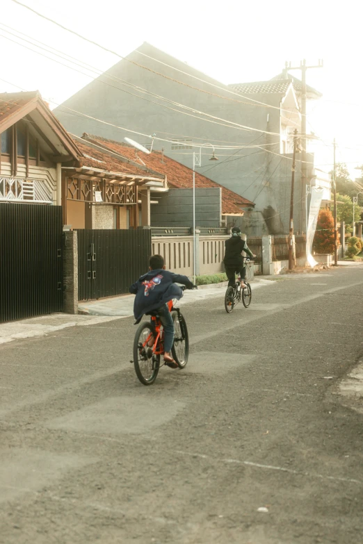 bicycles and a scooter riding down the road