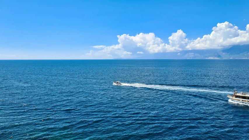 two boats are in the open water while one is out