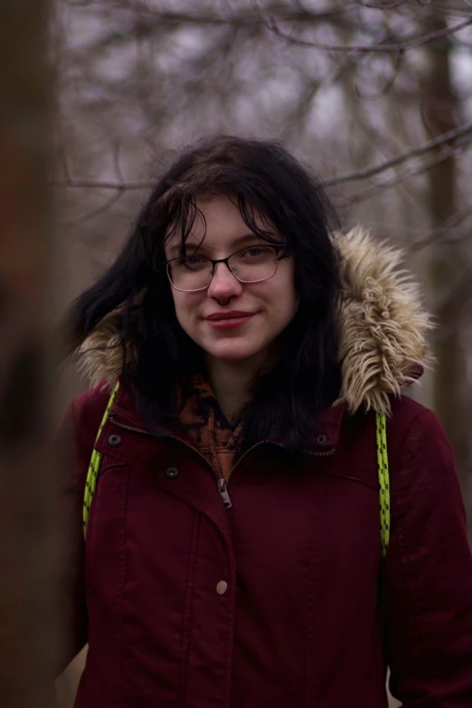 woman with glasses wearing red and looking away