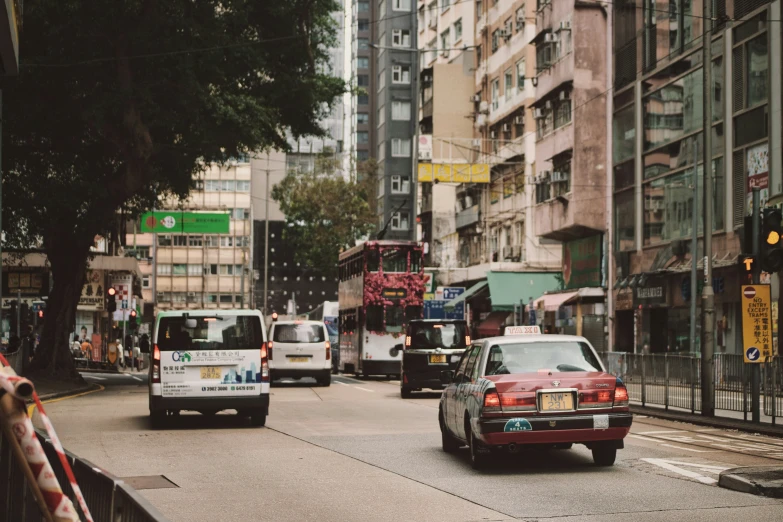 traffic drives down an urban street in a city