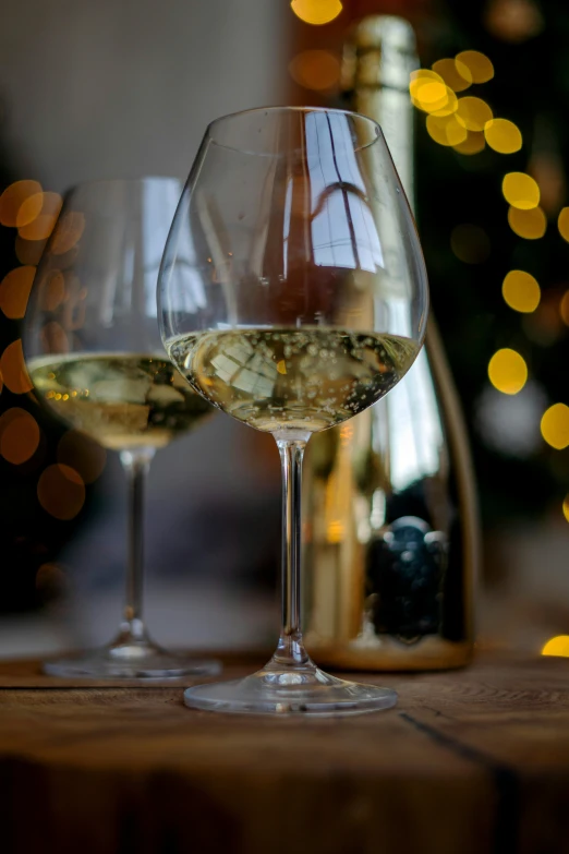 two wine glasses next to each other on a table