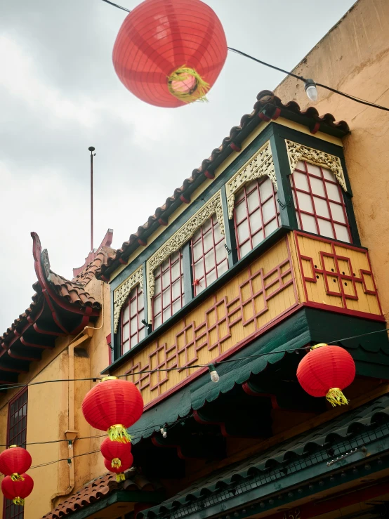 a red and green building is featured with red lanterns