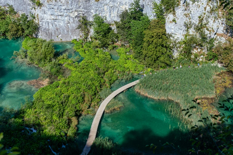 an aerial view shows the river running through a forested valley