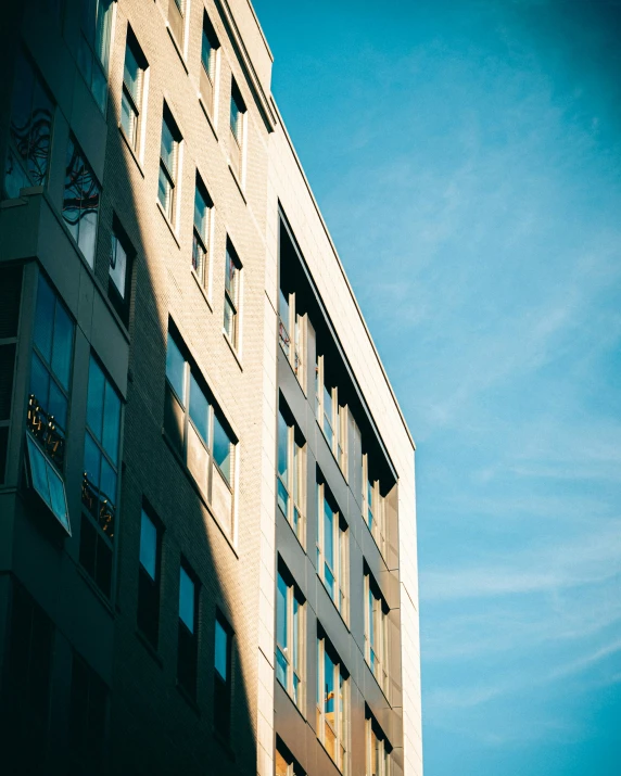 a building in the sun casting a shadow against it's wall