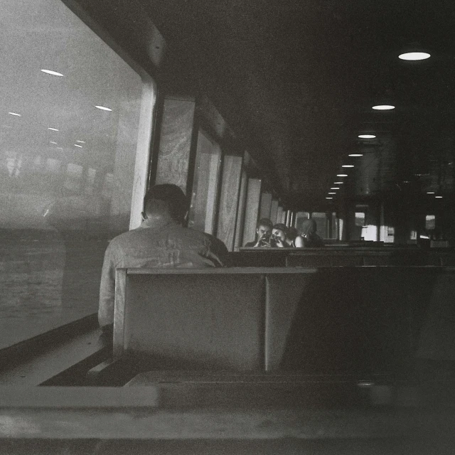 a man sitting at a desk near a window