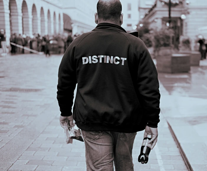 the back view of a man wearing a jacket with the word district printed on it