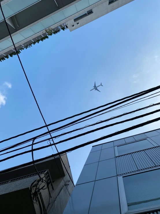 a very tall building with an air plane in the sky