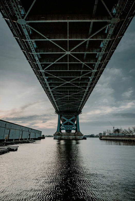 a bridge with a large metal structure in the water