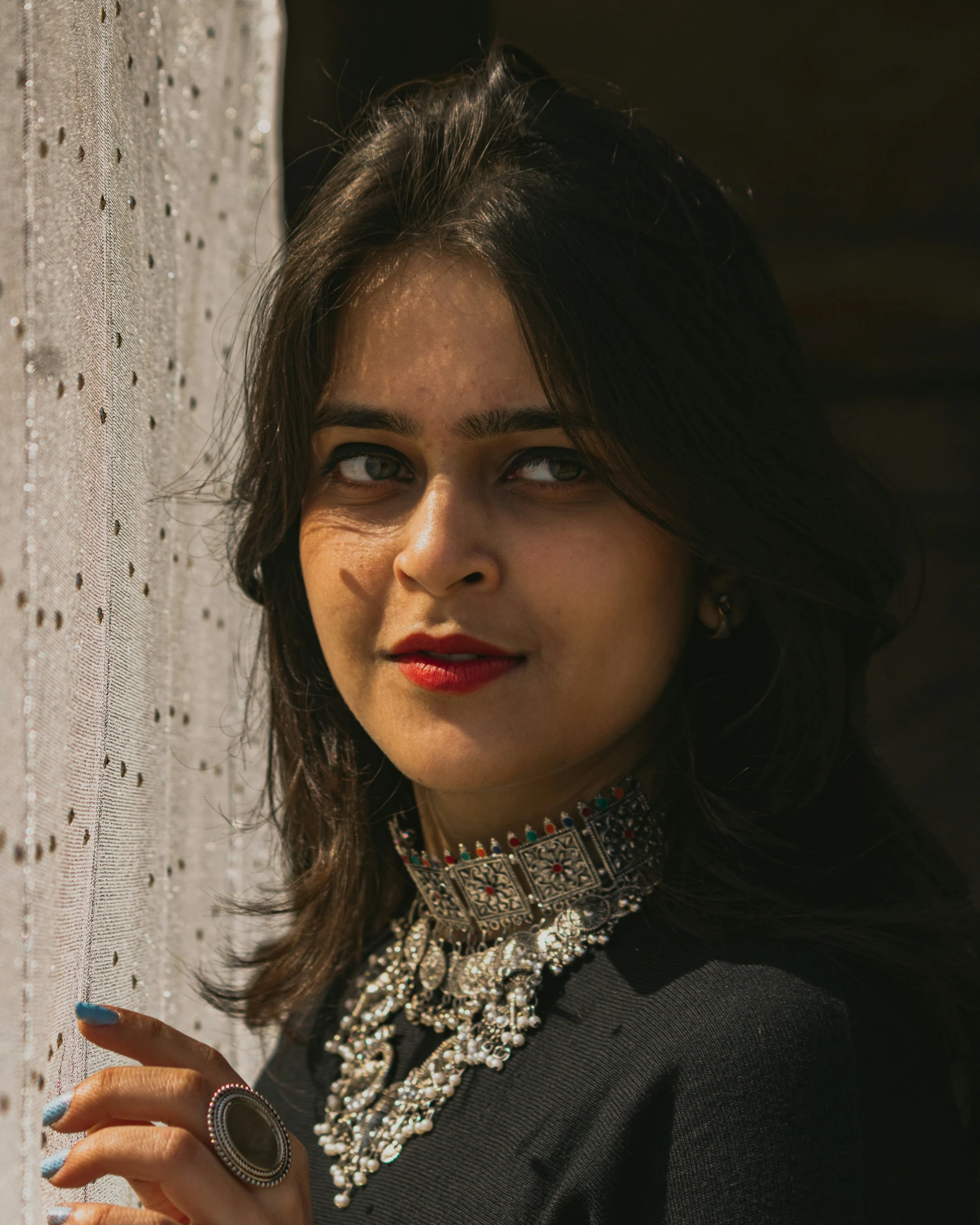 a woman is posing for a picture holding soing in her hands