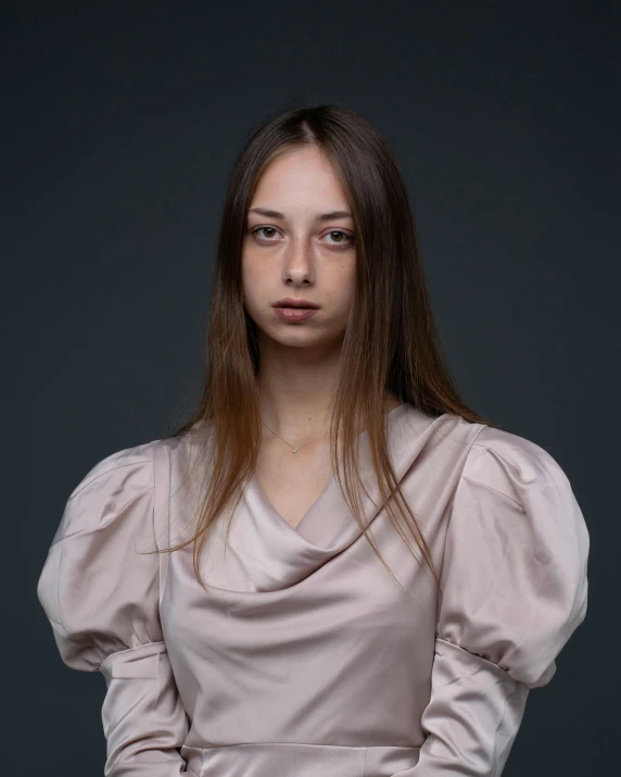 a young woman poses for a picture in her pink dress