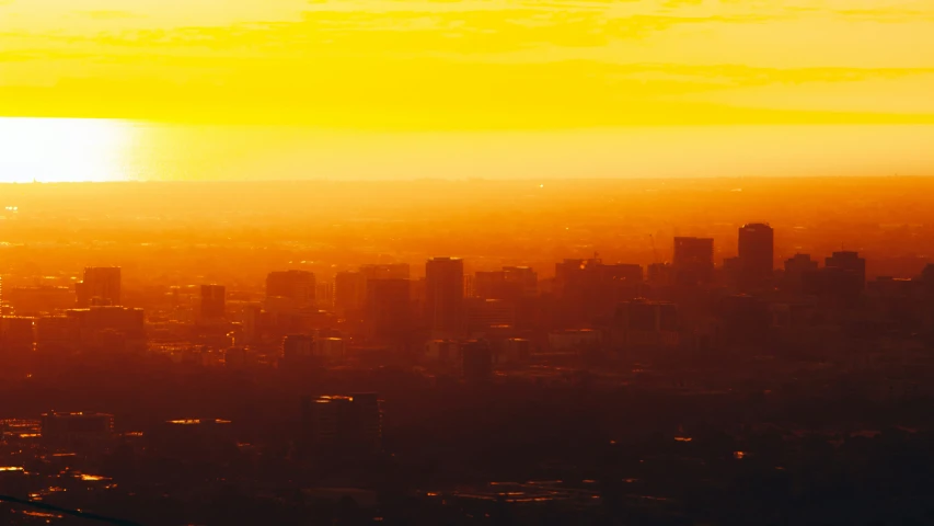 a city is seen at sunset in the distance