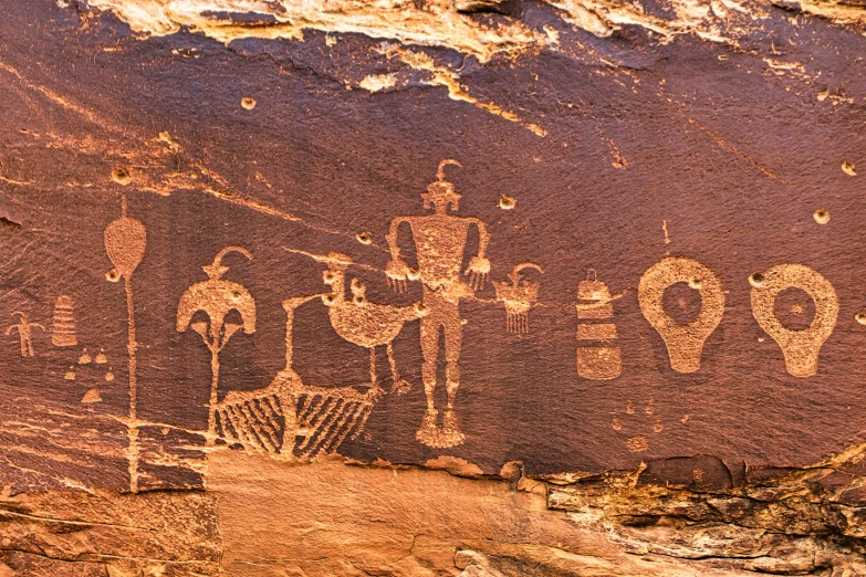 the rock wall shows an elaborate painting depicting people