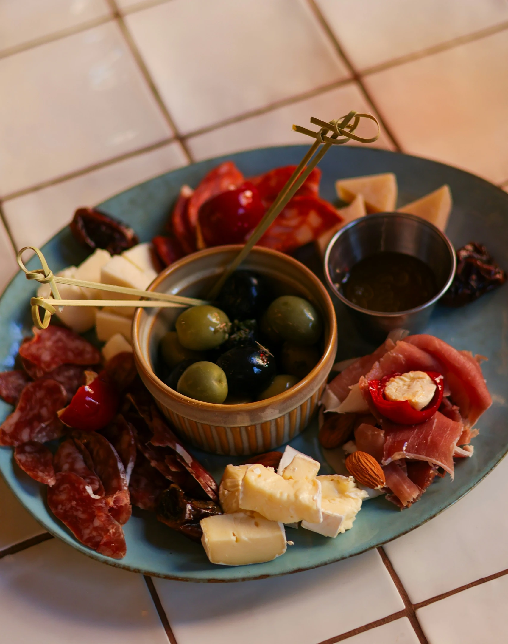 assorted appetizers sitting on a blue plate with matching cups