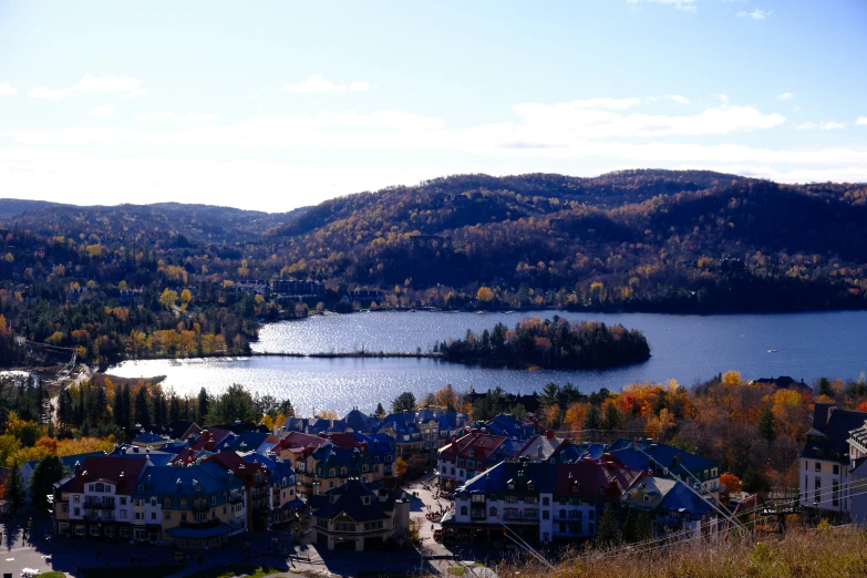 a small village is on the mountain with a lake