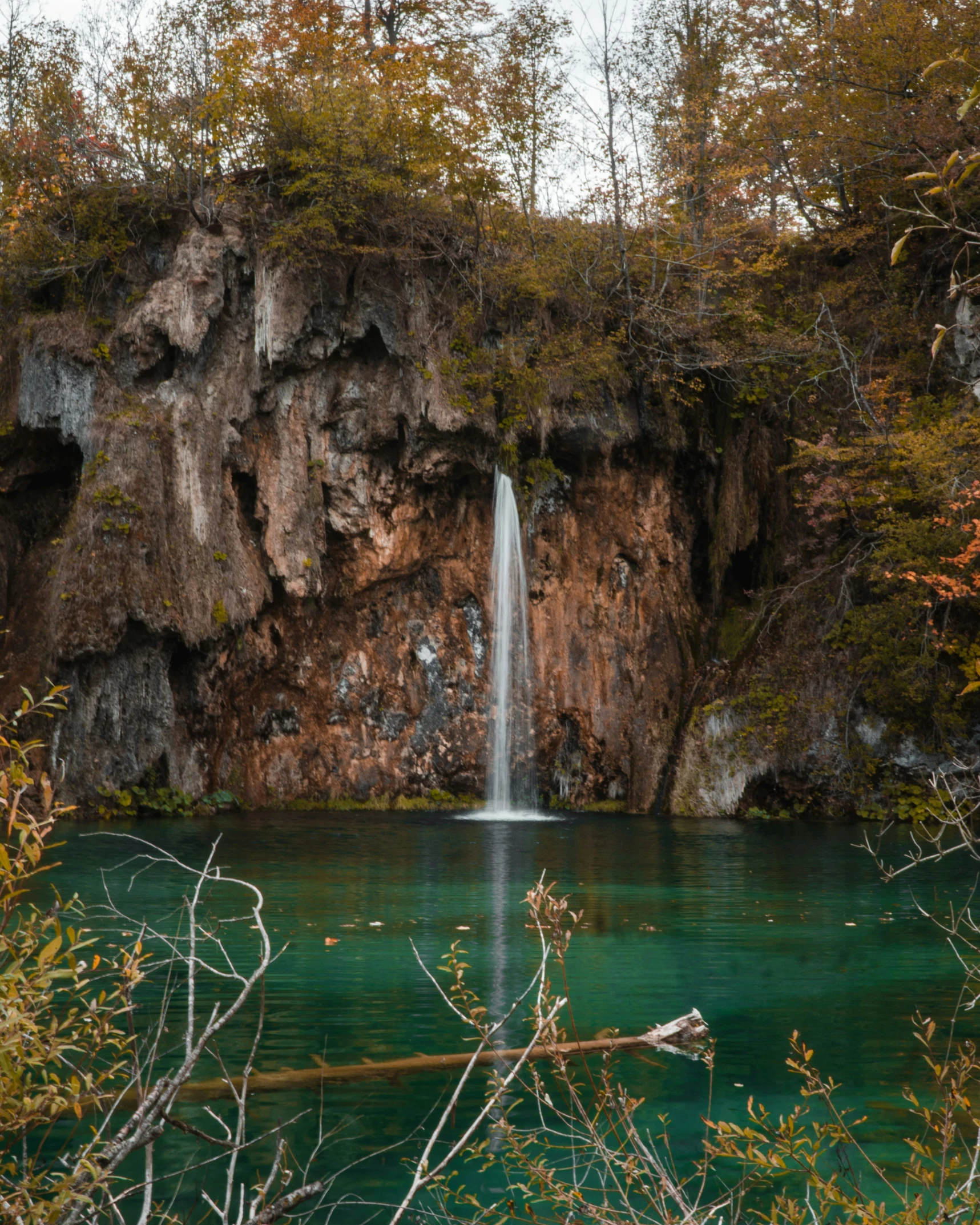 the waterfall is falling off of its cliff