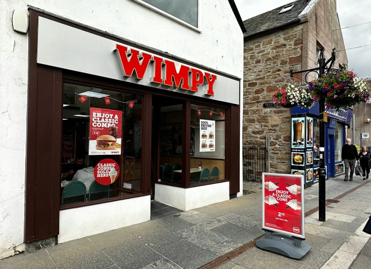 a storefront of a restaurant and in the street