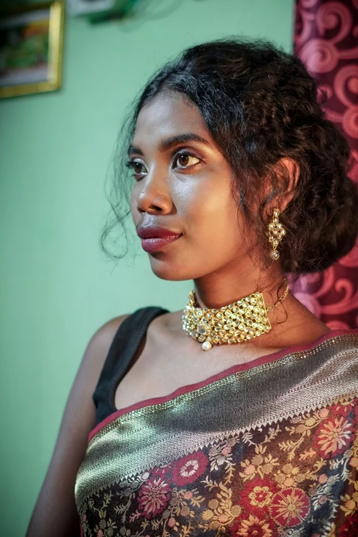 a woman in an indian blouse wearing a necklace