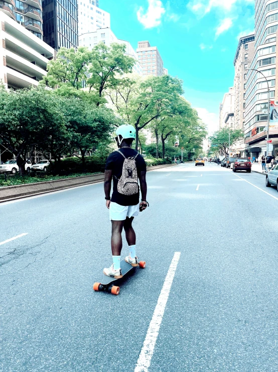 the man is riding his skateboard in the middle of the street