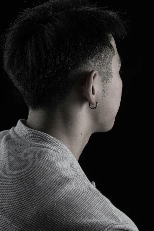 a woman with a haircut and piercings on