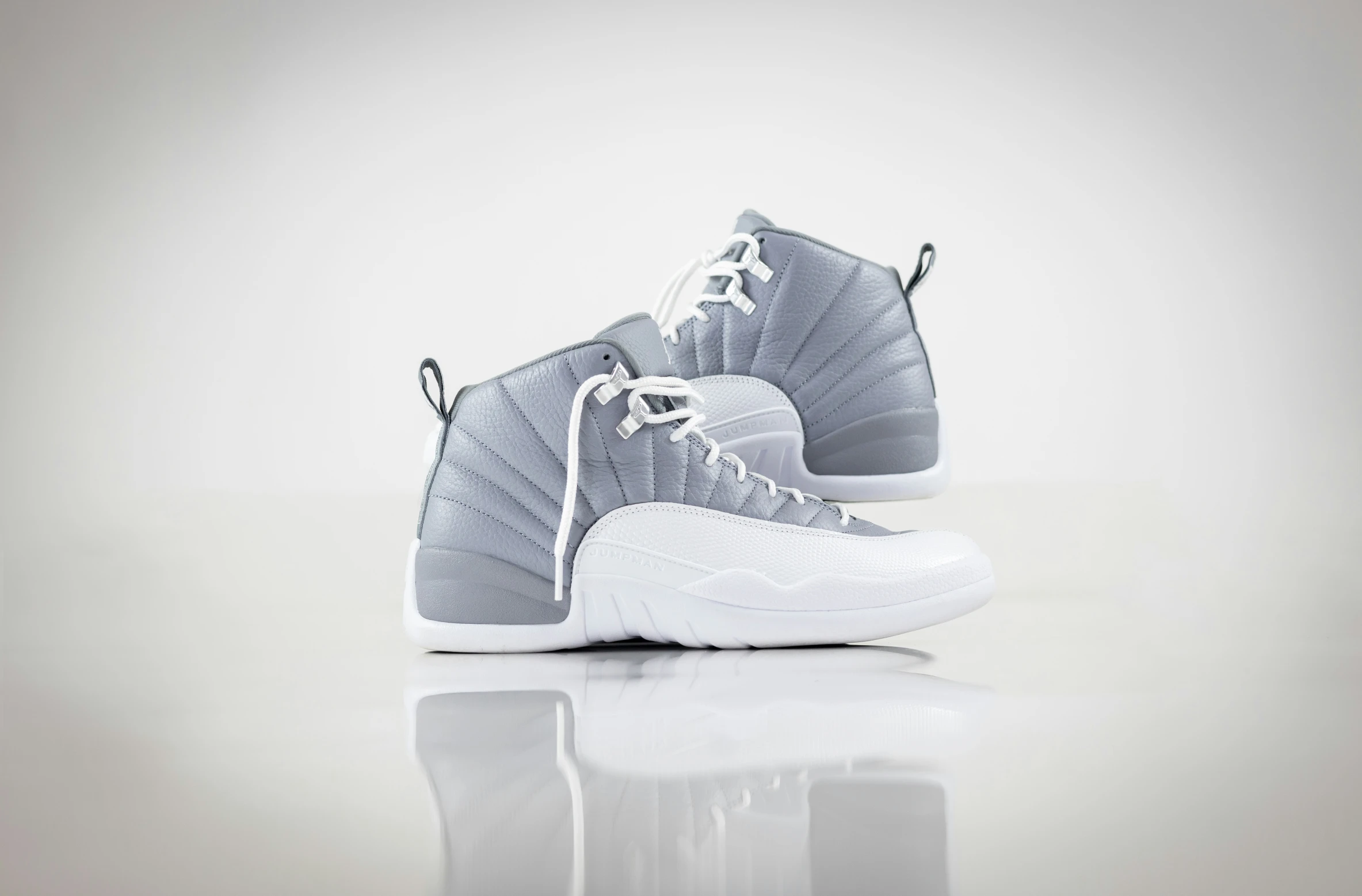 grey air jordan 11s on a white surface