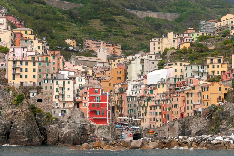 a city with colorful buildings, cliffs and a beach