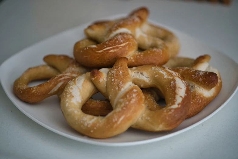 a group of pretzels sitting on top of a white plate