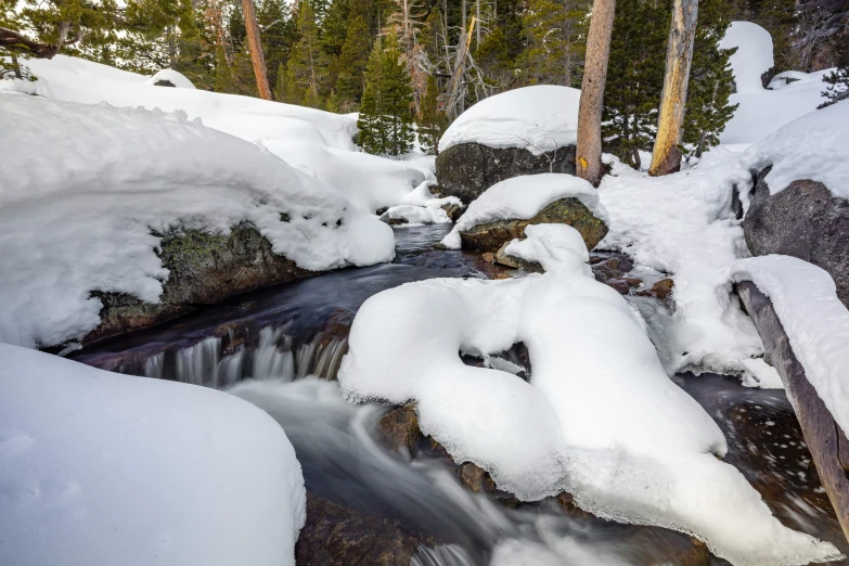 a small stream is shown flowing through a snowy area