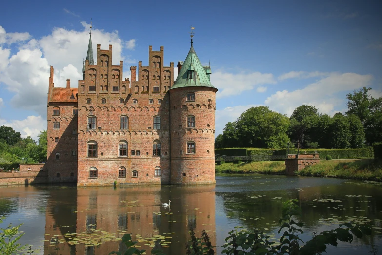 an old brick castle by the lake and trees